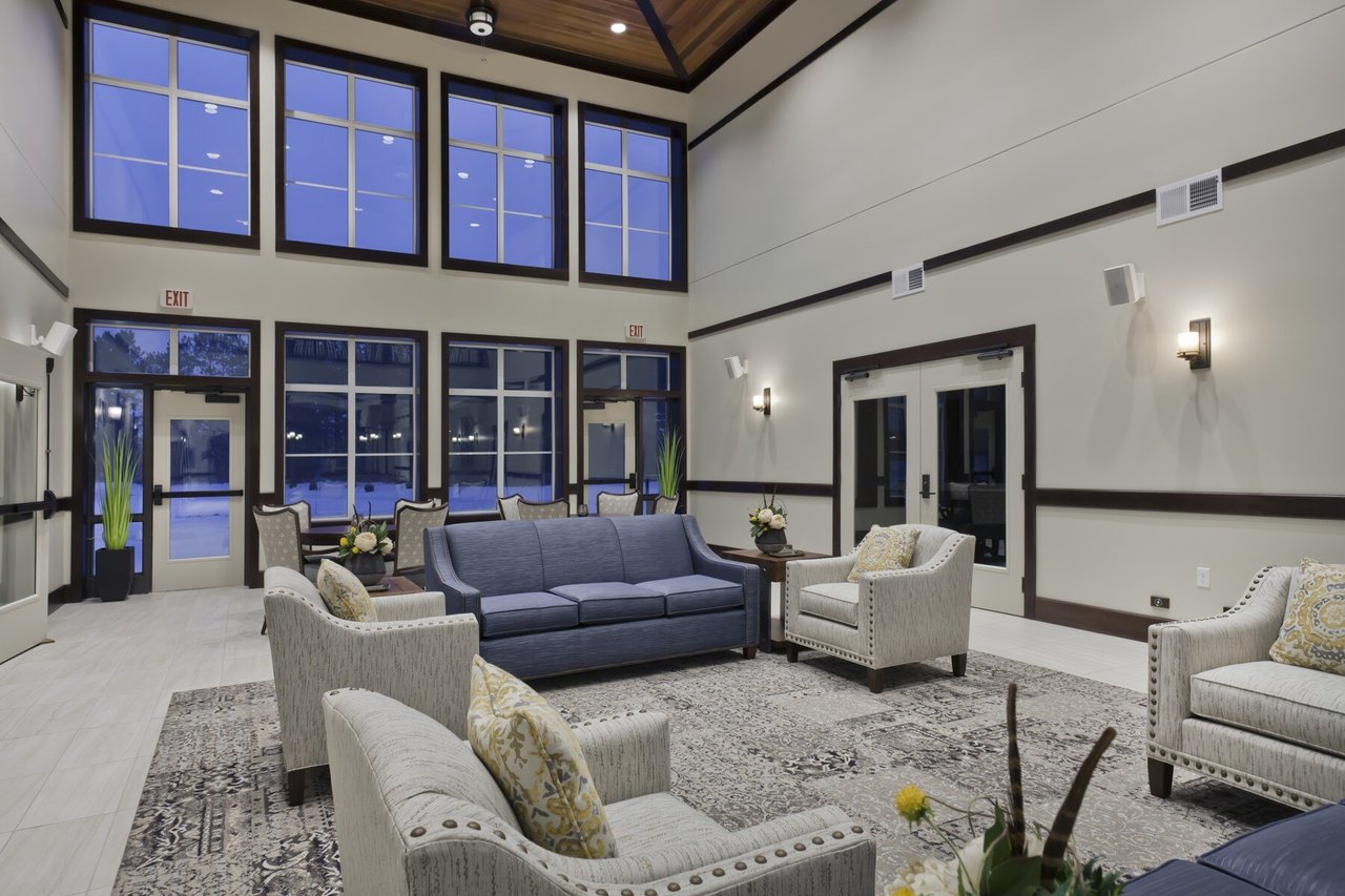 large white room with high ceilings and huge windows