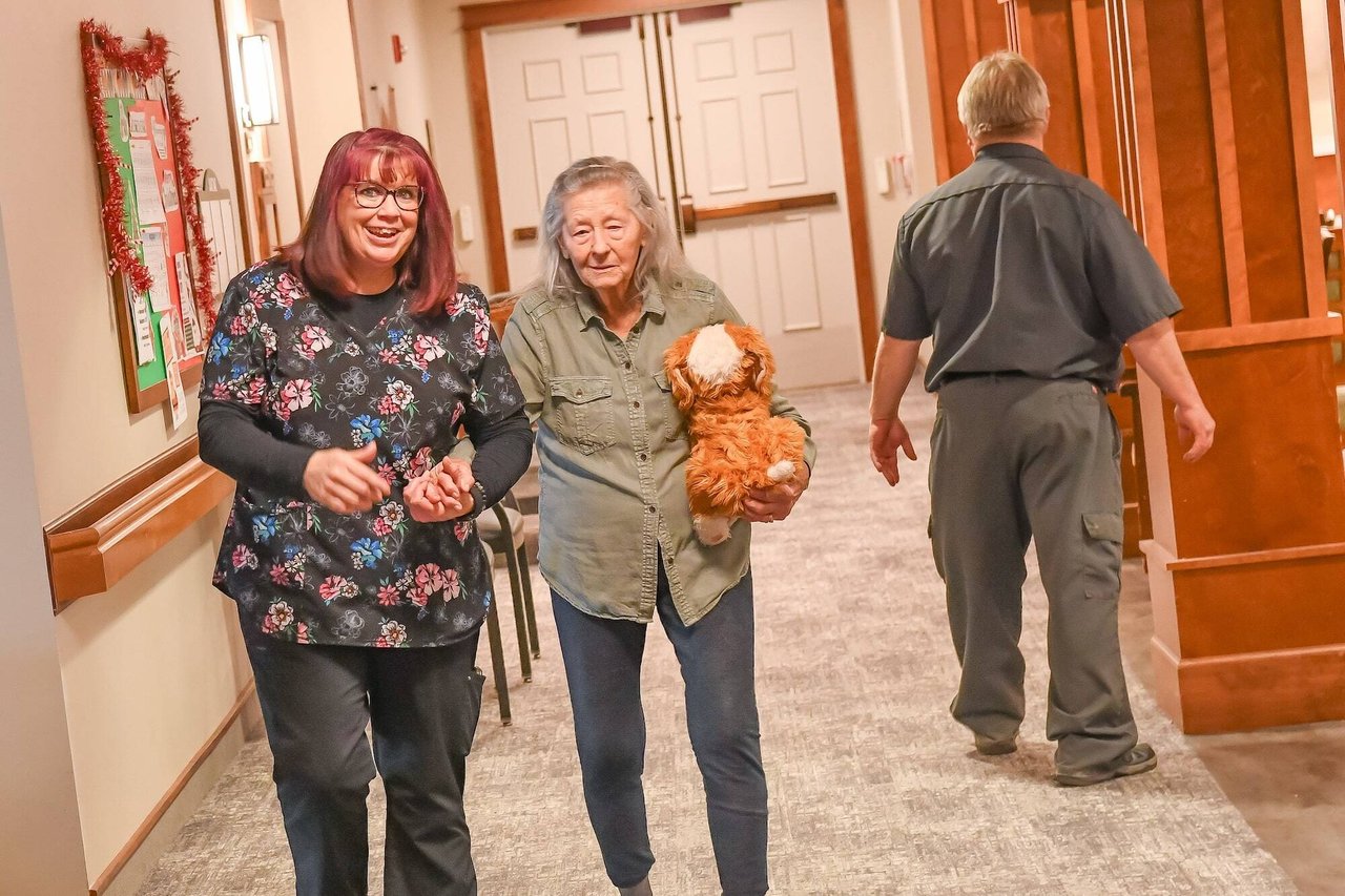 nurse with woman in hallway