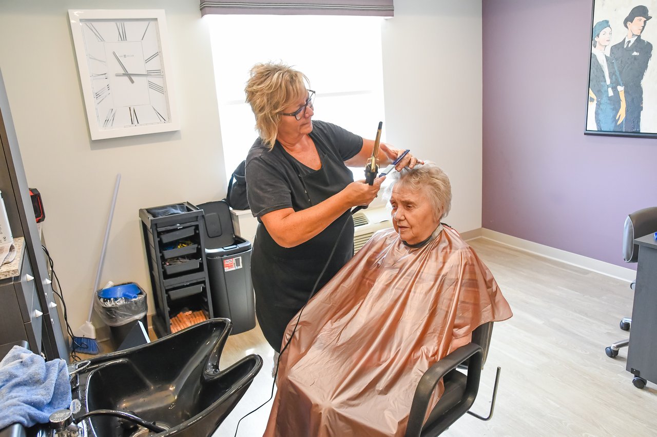 women in salon getting haircut