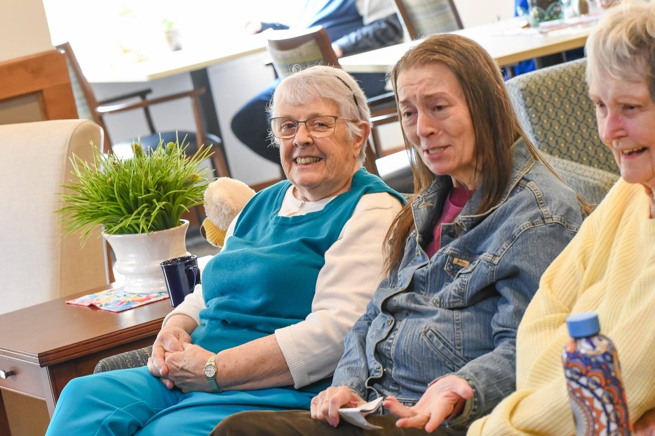 smiling seniors on couch