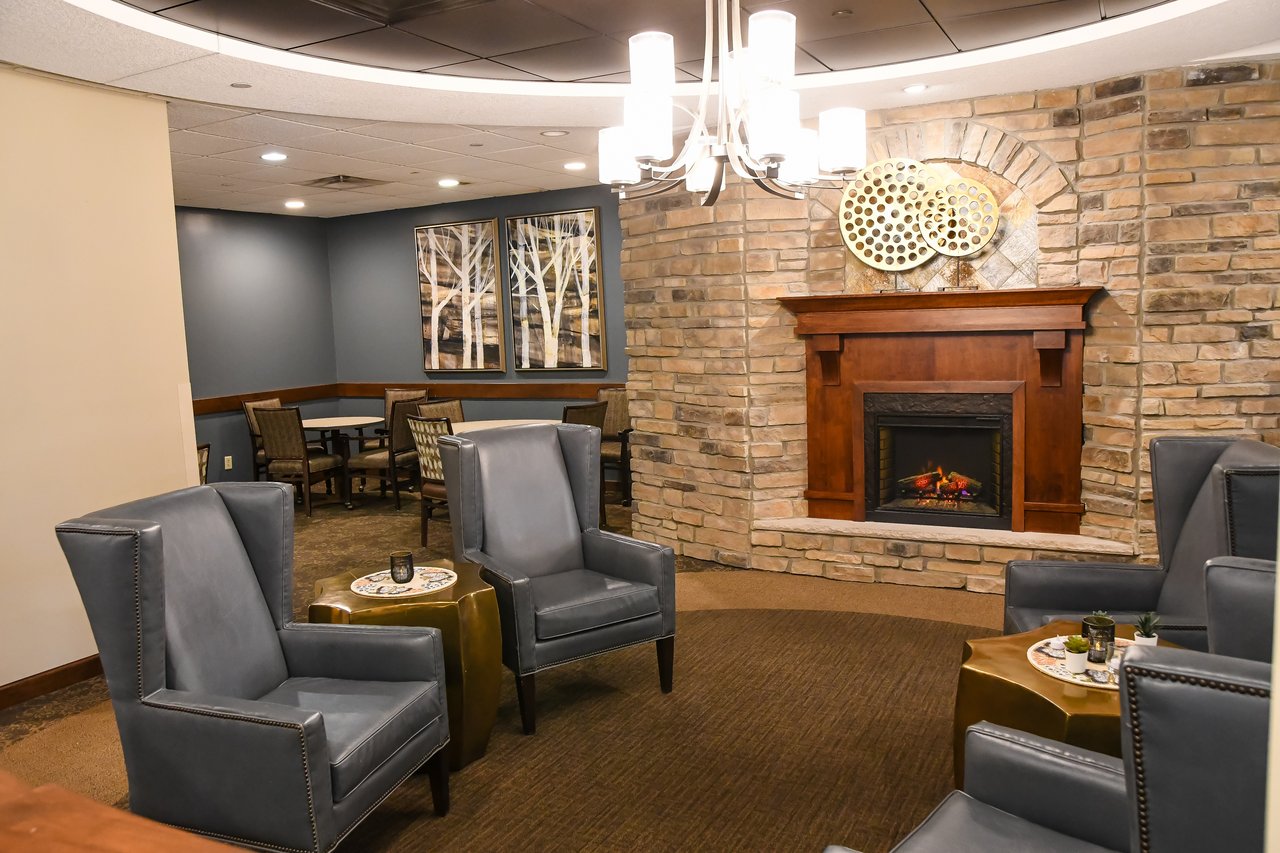 lobby with chairs, chandelier, and fireplace