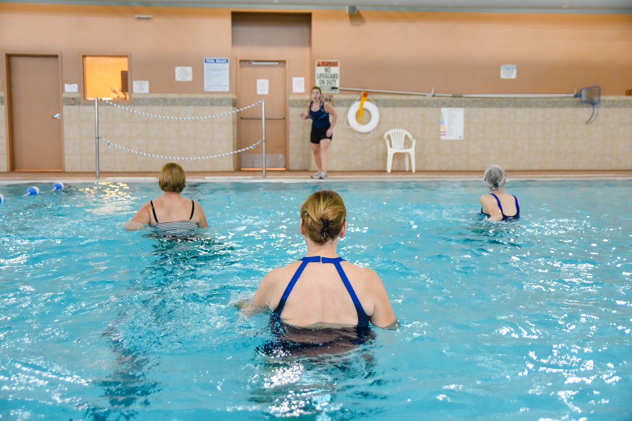 women exercising in open pool