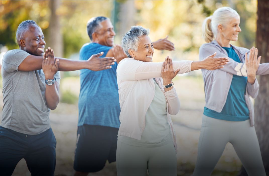 Photo of adults stretching in park