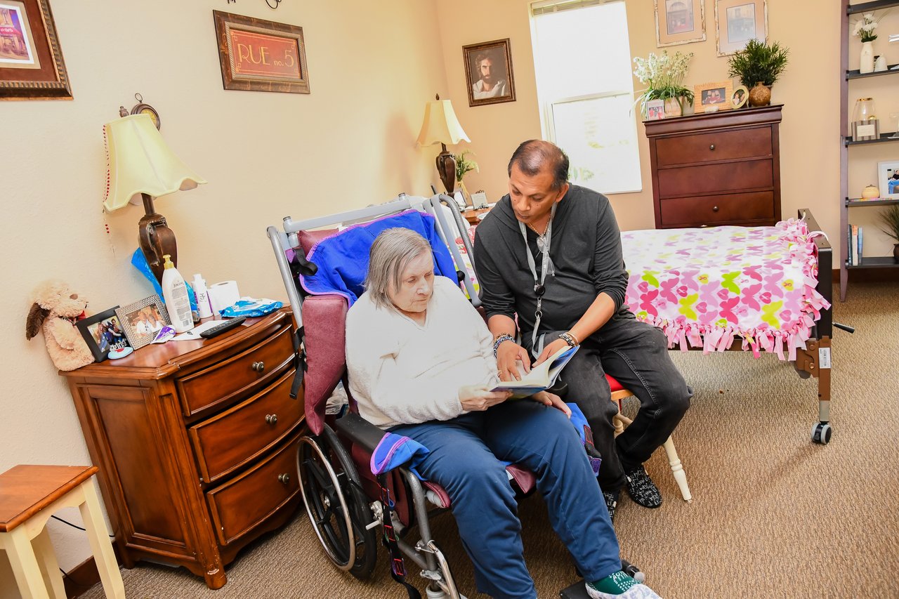 nurse helping woman in wheelchair