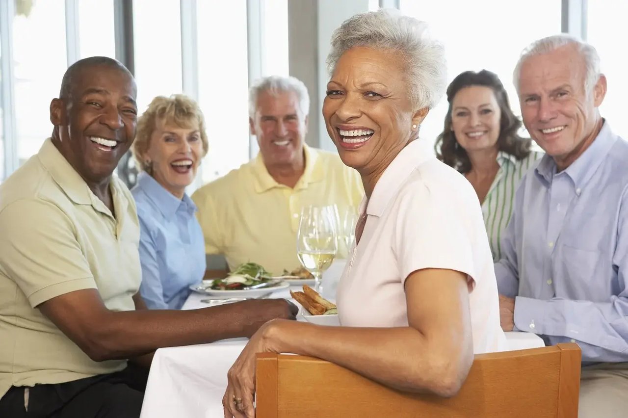 smiling group of seniors at table