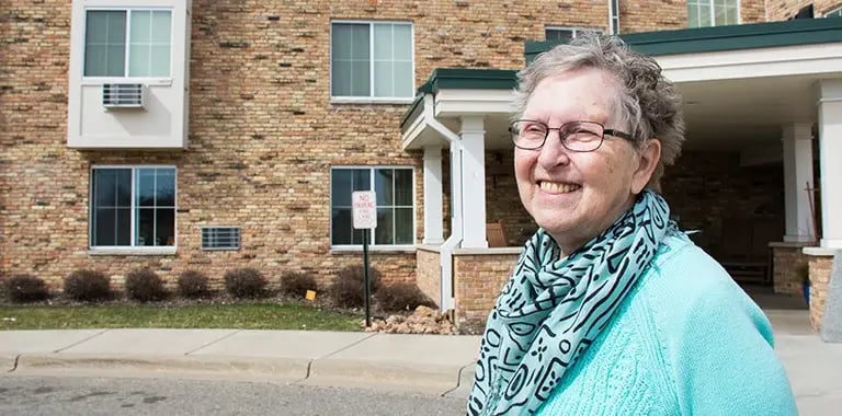 smiling woman outside community building