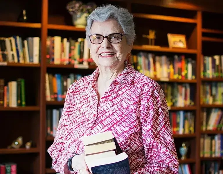 older woman smiling in library