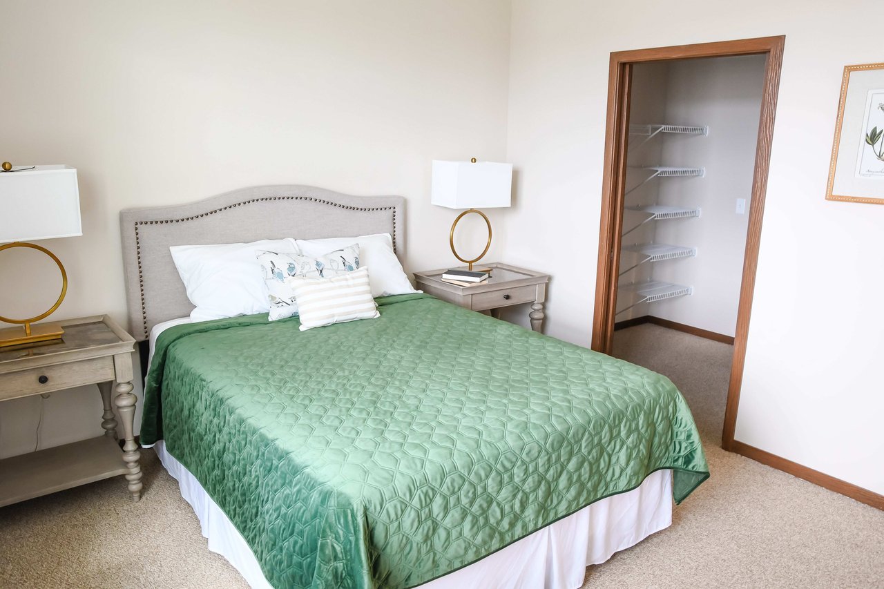 room with bed and green quilt