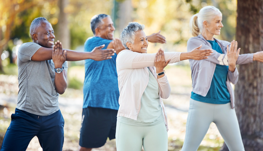 group of adults stretching in park