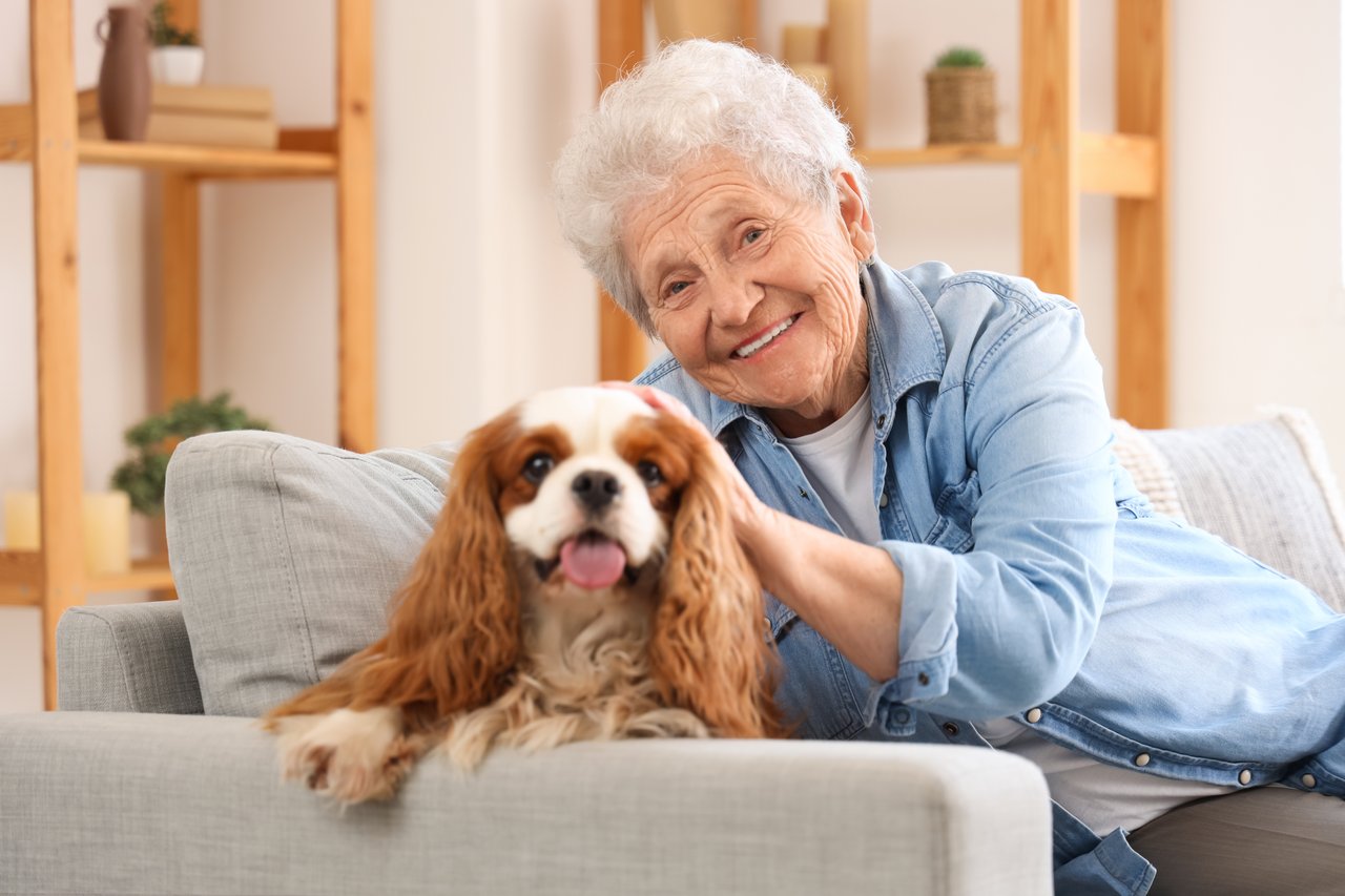 Photo of a woman in senior living with her dog