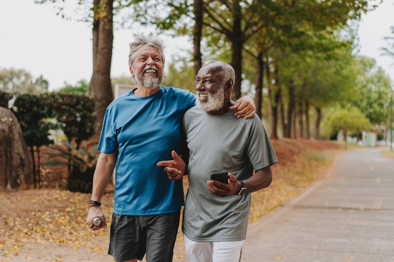 two men on walking path laughing together